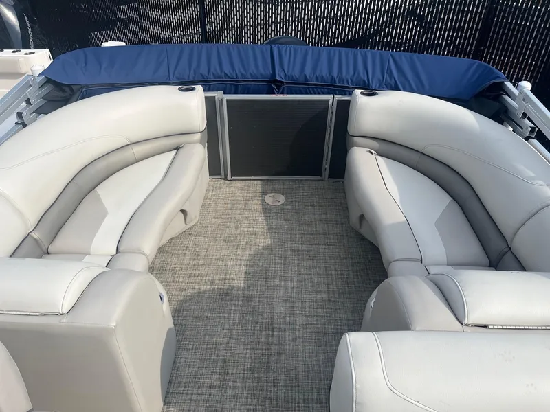 Slide: The Image of 2022 Cypress Cay Seabreeze 232 boat interior with plush seating and carpeted floor. - 7