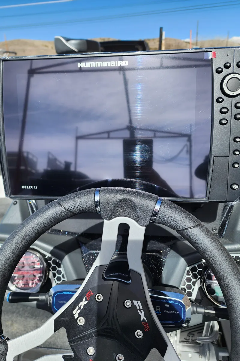Slide: The Image of 2024 Skeeter FXR 20 Limited boat dashboard with Humminbird Helix 12 display. - 12