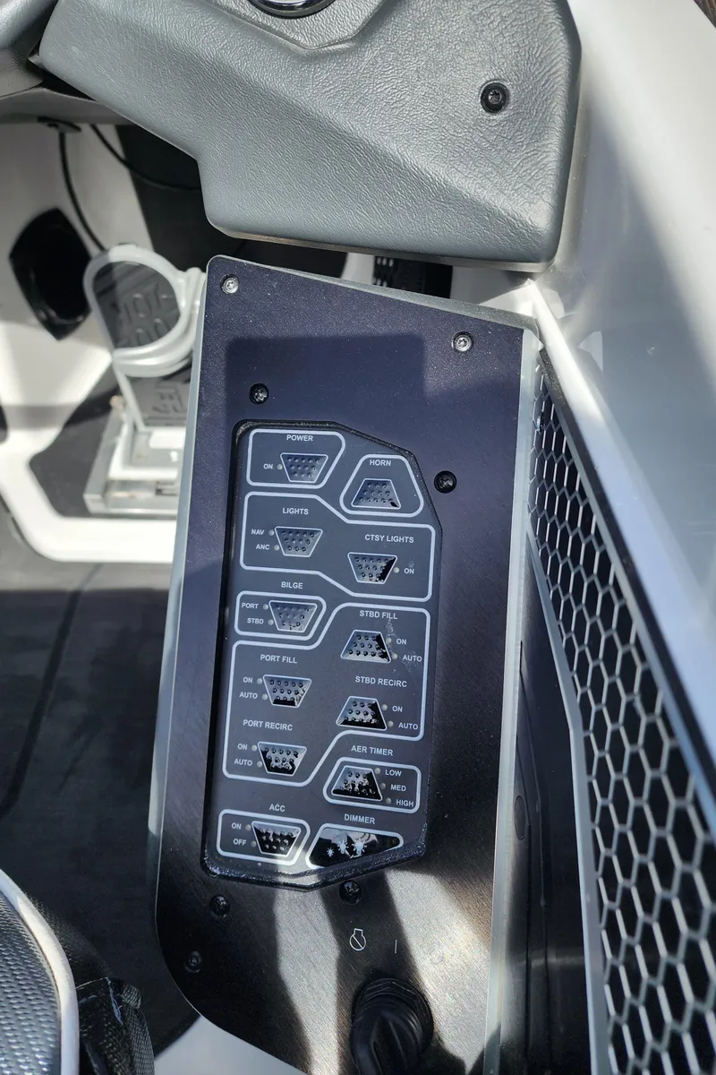 Slide: The Image of 2024 Skeeter FXR 20 Limited boat dashboard with control panel and switches. - 13