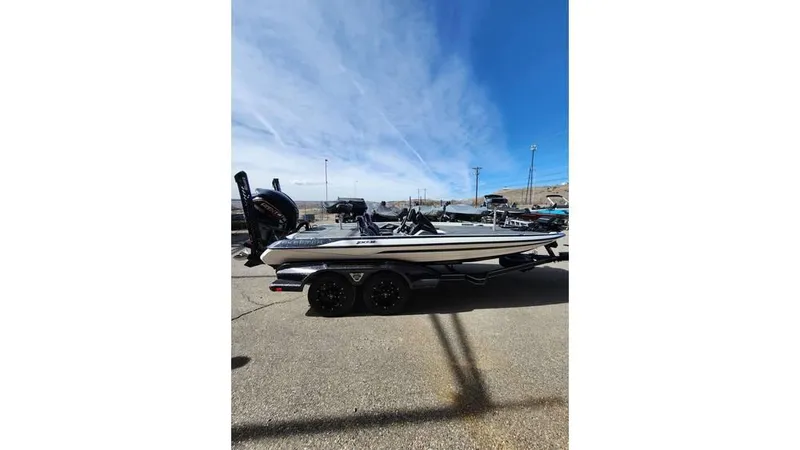 Slide: The Image of 2024 Skeeter FXR 20 Limited boat parked outdoors under clear blue sky. - 4