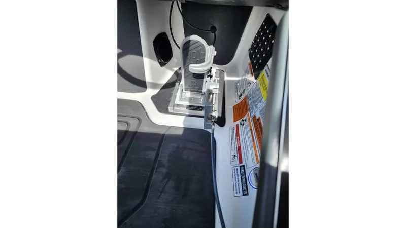 Slide: The Image of 2024 Skeeter FXR 20 Limited boat interior with foot pedal and safety labels. - 8