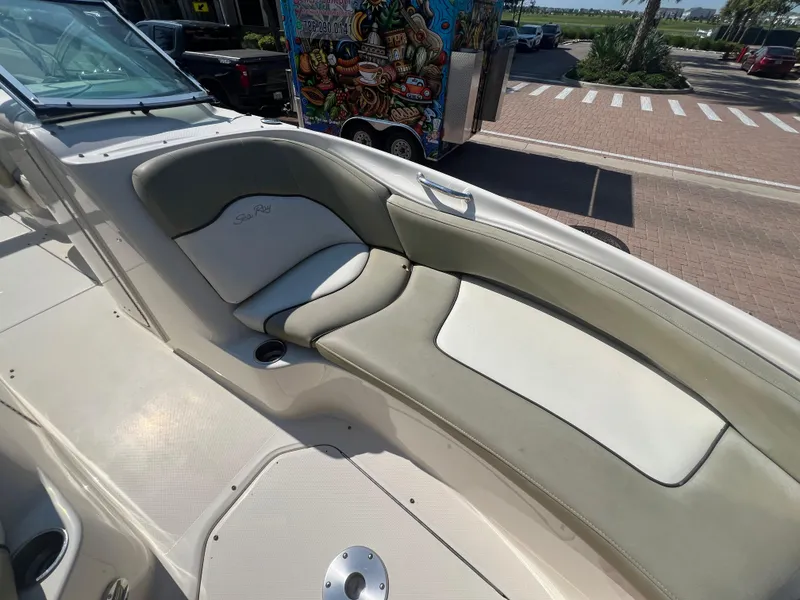 Slide: The Image of 2006 Sea Ray 240 Sundeck boat interior with beige seating. - 10