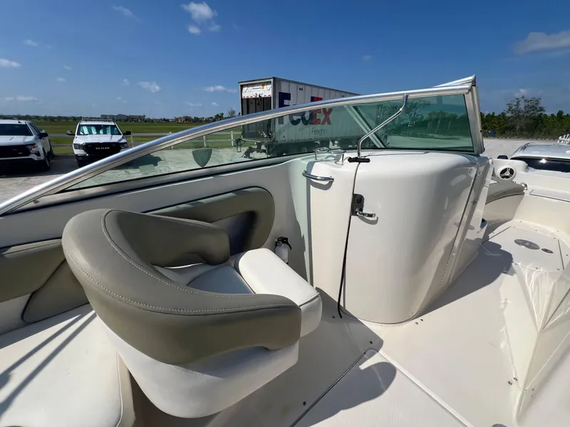 Slide: The Image of 2006 Sea Ray 240 Sundeck boat interior with seating and windshield. - 12