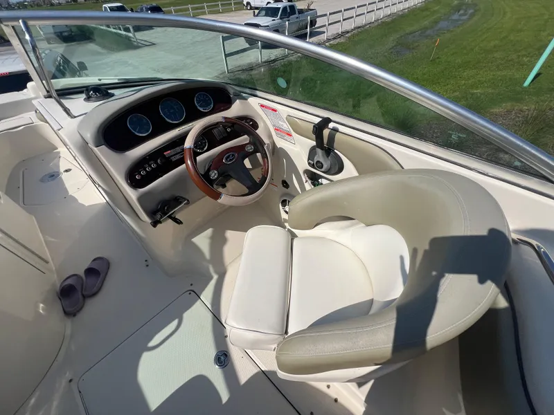 Slide: The Image of 2006 Sea Ray 240 Sundeck boat cockpit with steering wheel and dashboard. - 15