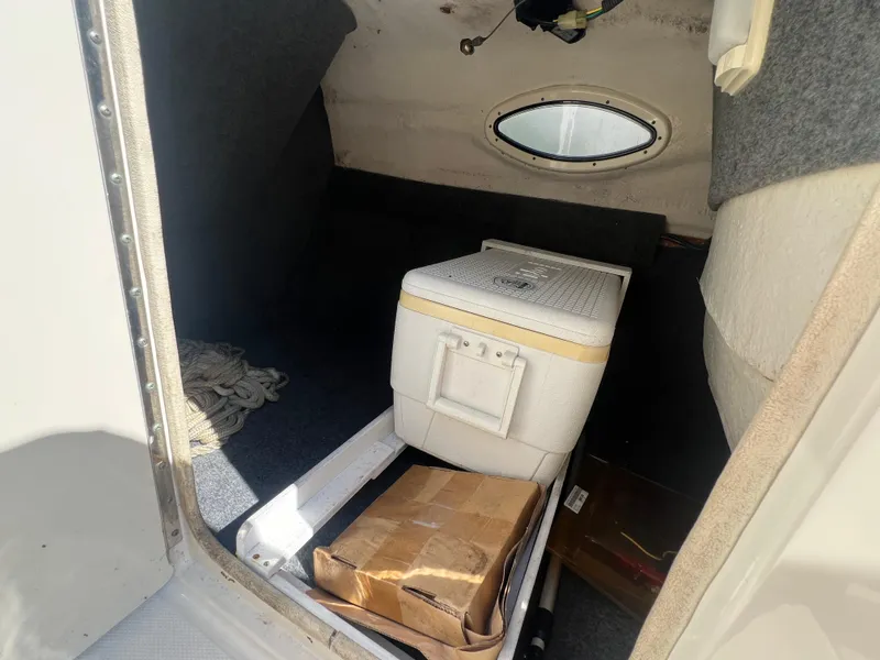 Slide: The Image of Interior cabin of 2006 Sea Ray 240 Sundeck with cooler and storage box. - 18