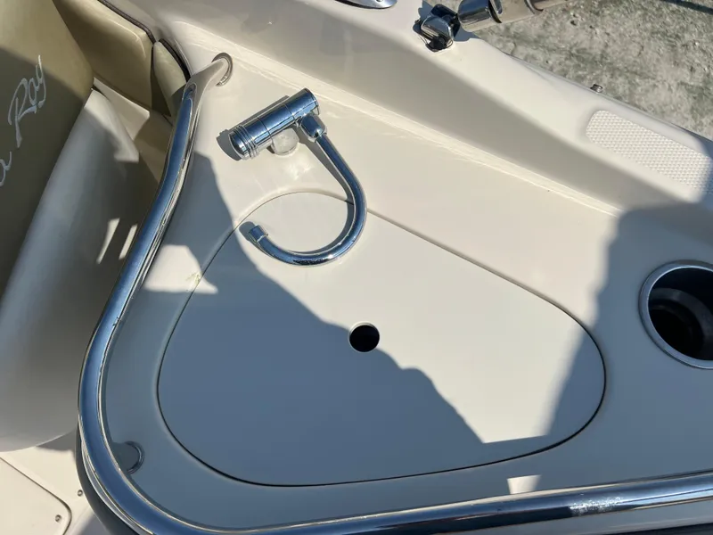 Slide: The Image of 2006 Sea Ray 240 Sundeck boat interior with chrome fixtures and seating area. - 19