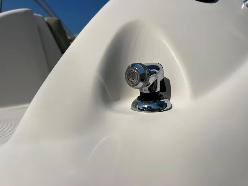 Slide: The Image of Close-up of a 2006 Sea Ray 240 Sundeck boat detail, featuring a chrome fixture. - 25