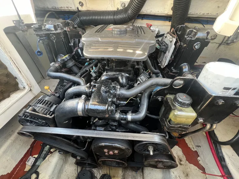 Slide: The Image of 2006 Sea Ray 240 Sundeck engine, detailed view of mechanical components. - 26