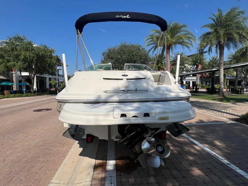 Slide: The Image of 2006 Sea Ray 240 Sundeck boat parked on a sunny street. - 32