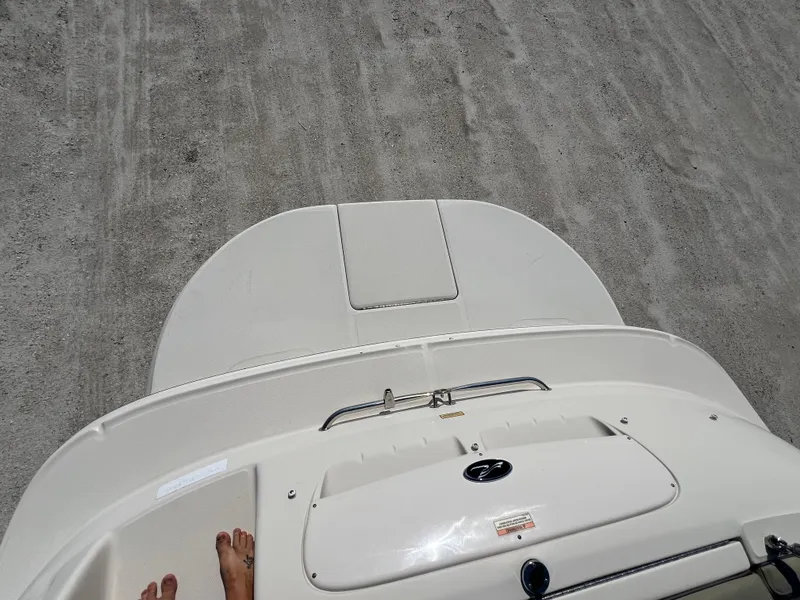 Slide: The Image of 2006 Sea Ray 240 Sundeck boat deck with sandy background. - 34