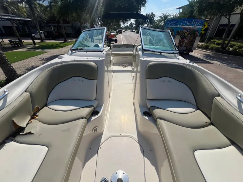 Slide: The Image of 2006 Sea Ray 240 Sundeck boat interior with seating and open windshield. - 7