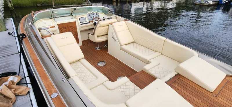 Slide: The Image of 2017 Chris-Craft Corsair 32 boat with luxurious seating and wooden deck. - 15