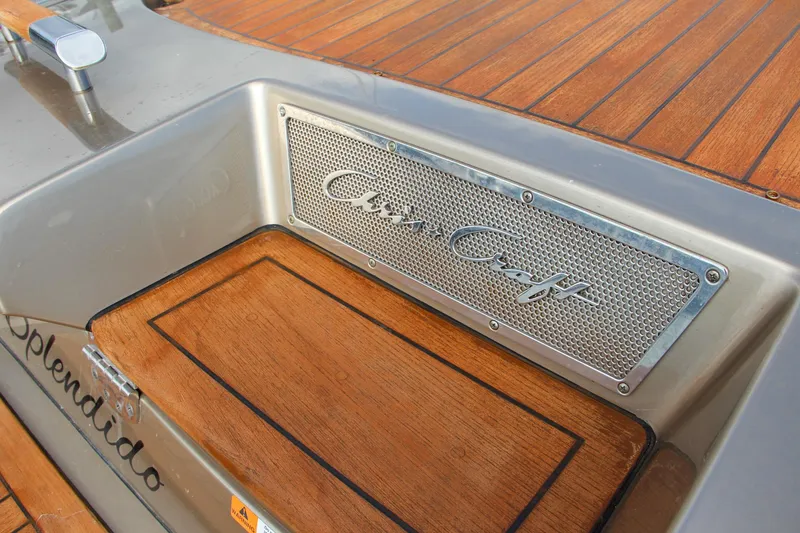 Slide: The Image of 2017 Chris-Craft Corsair 32 boat with wooden deck and branded metal detailing. - 20