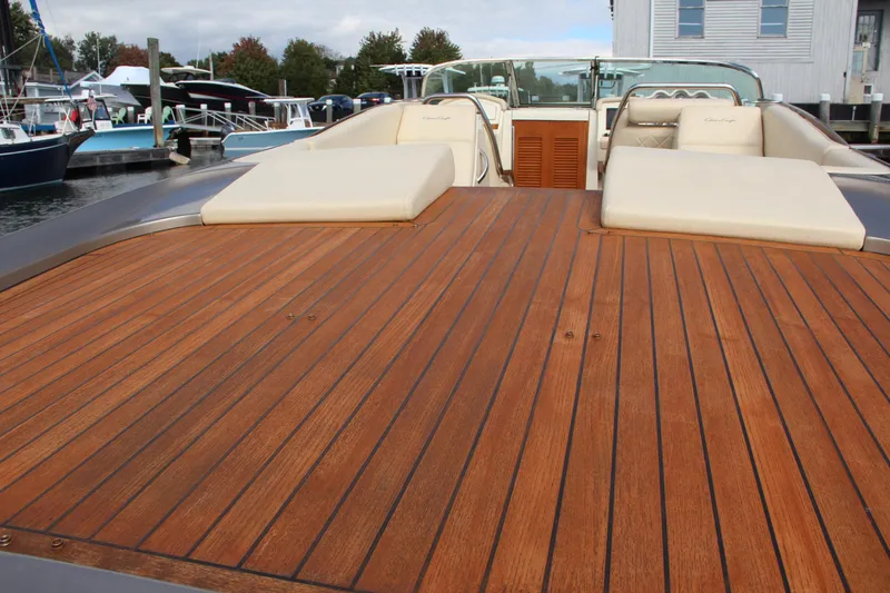 Slide: The Image of 2017 Chris-Craft Corsair 32 with teak deck and cushioned seating at a marina. - 21