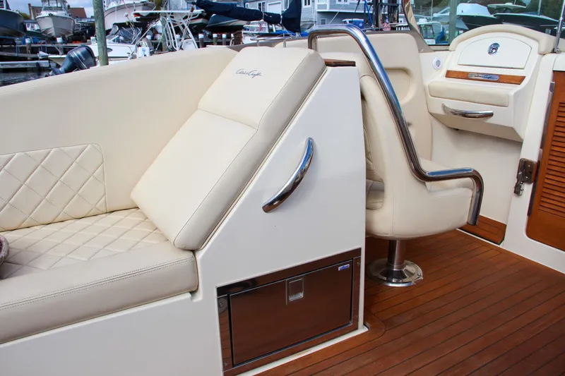 Slide: The Image of Luxurious interior of 2017 Chris-Craft Corsair 32 with beige seating and wood accents. - 23