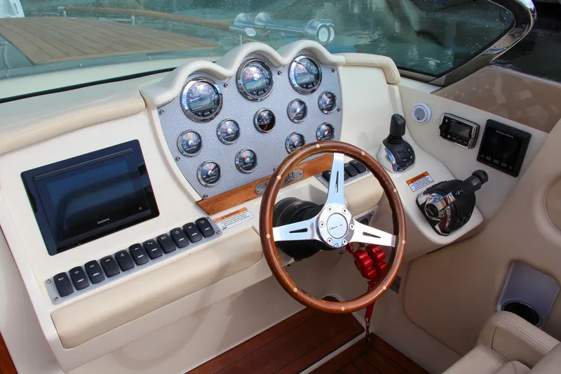 Slide: The Image of 2017 Chris-Craft Corsair 32 dashboard with wood steering wheel and modern controls. - 27