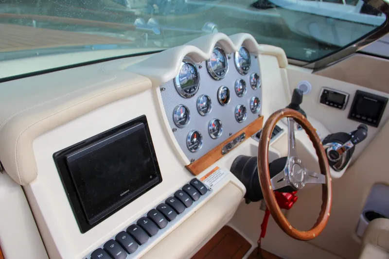 Slide: The Image of 2017 Chris-Craft Corsair 32 dashboard with gauges, steering wheel, and control panel. - 29