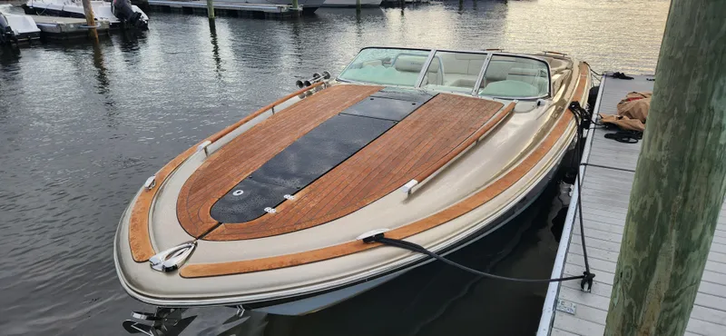 Slide: The Image of 2017 Chris-Craft Corsair 32 boat docked, featuring elegant wood detailing. - 3