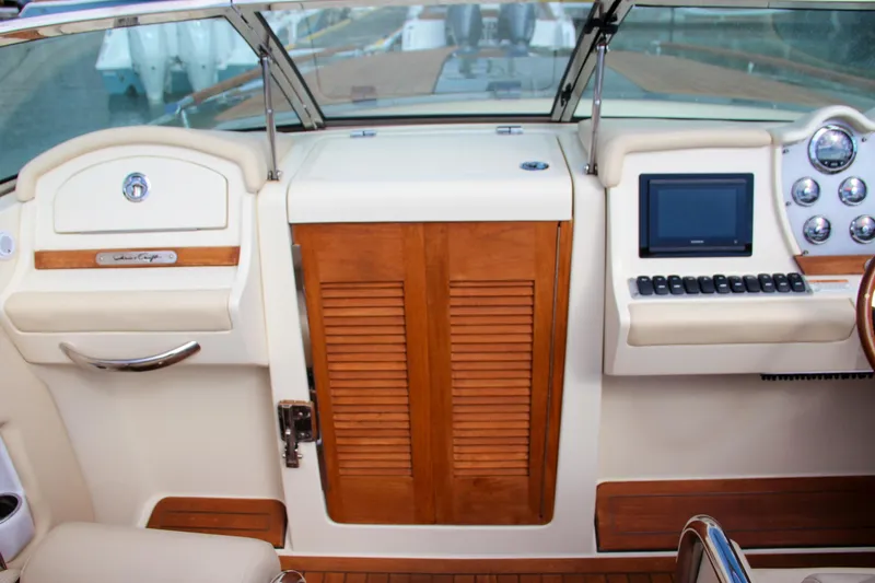 Slide: The Image of 2017 Chris-Craft Corsair 32 cockpit with wood accents and modern controls. - 32