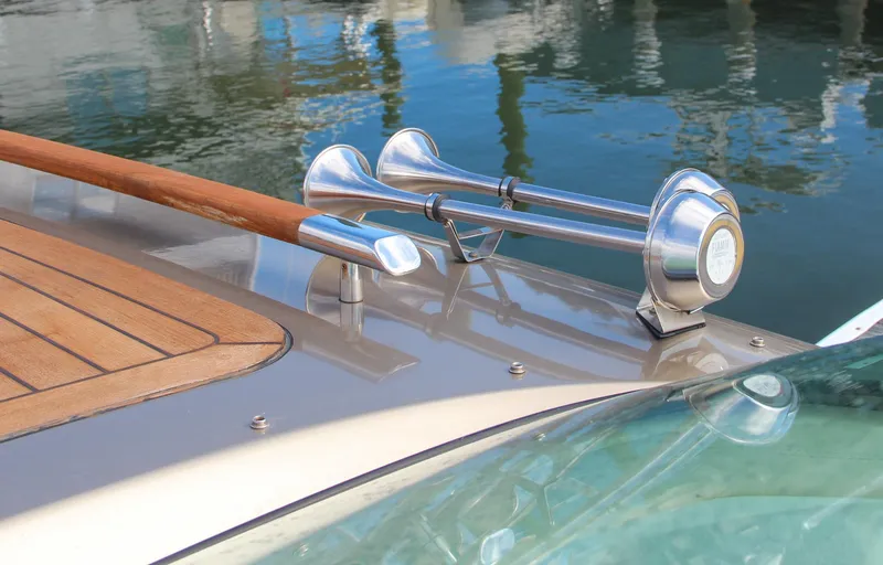 Slide: The Image of 2017 Chris-Craft Corsair 32 boat detail with wooden deck and chrome horn. - 33