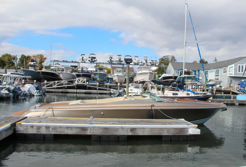 Slide: The Image of 2017 Chris-Craft Corsair 32 docked at a marina with other boats. - 38