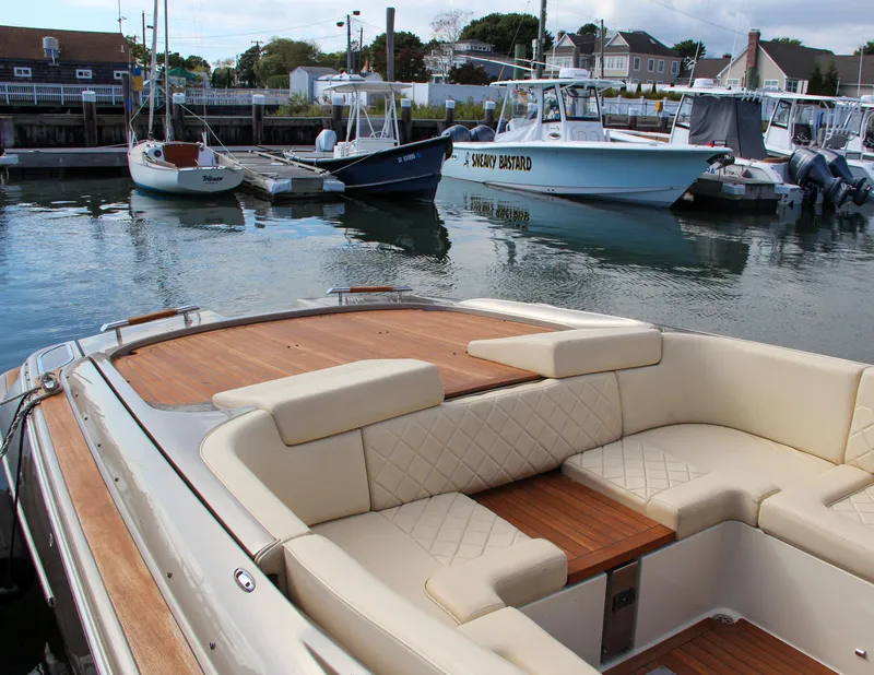 Slide: The Image of 2017 Chris-Craft Corsair 32 with elegant seating, docked in a serene marina. - 4