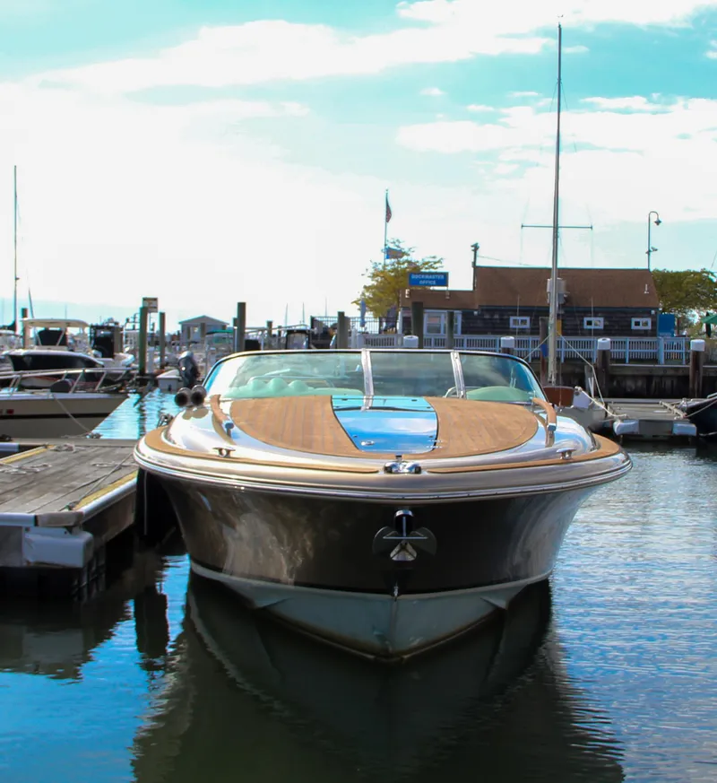 Slide: The Image of 2017 Chris-Craft Corsair 32 docked at a marina, showcasing sleek design and luxury. - 40