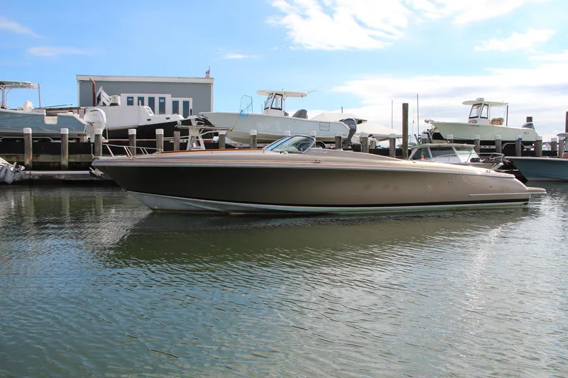 Slide: The Image of 2017 Chris-Craft Corsair 32 boat docked in marina under blue sky. - 43