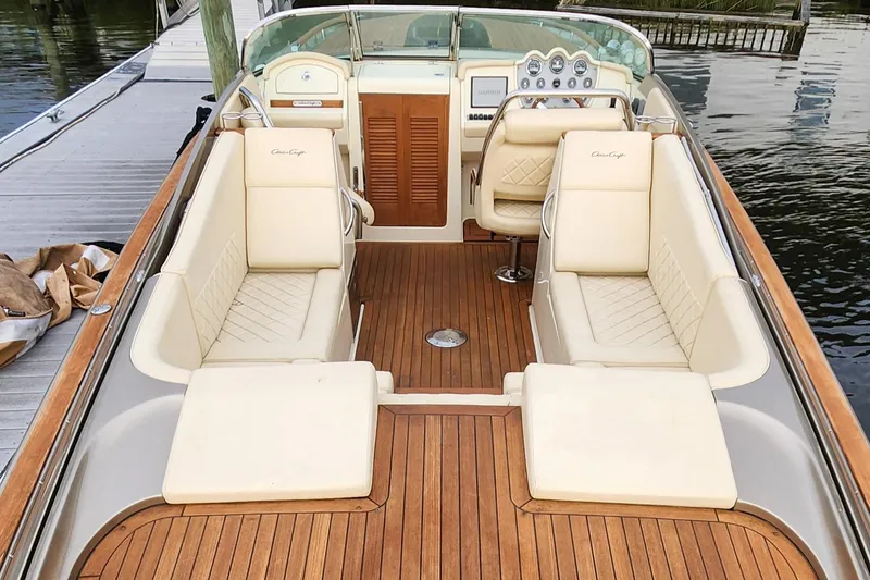 Slide: The Image of 2017 Chris-Craft Corsair 32 boat interior with luxurious seating and wooden deck. - 5