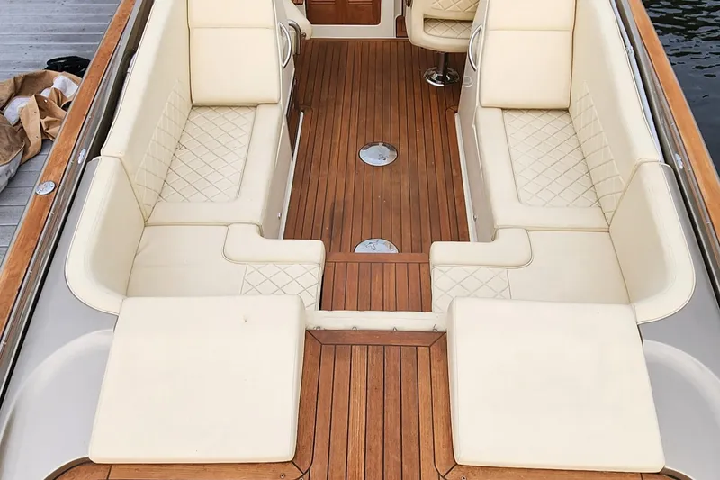 Slide: The Image of 2017 Chris-Craft Corsair 32 interior with elegant cream seating and teak flooring. - 7