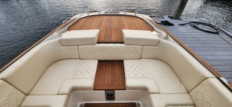 Slide: The Image of 2017 Chris-Craft Corsair 32 boat with elegant cream seating and wooden deck. - 8