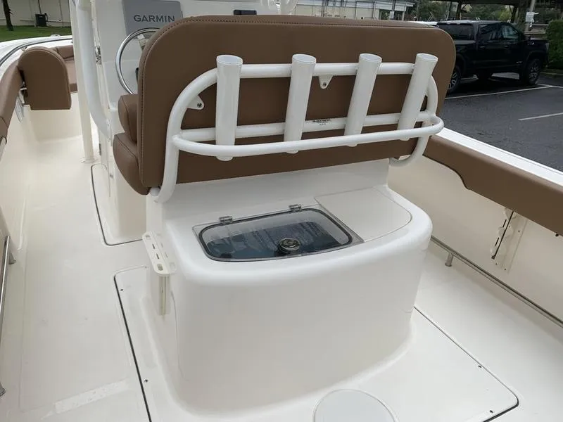 Slide: The Image of 2025 Pioneer SPORTFISH 222 boat interior with rod holders and seating. - 10