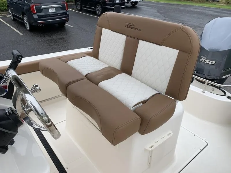 Slide: The Image of 2025 Pioneer SPORTFISH 222 boat seating with brown and white upholstery. - 12