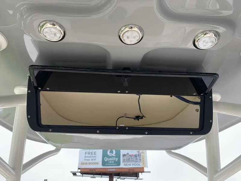 Slide: The Image of 2025 Pioneer SPORTFISH 222 boat console with overhead storage and LED lights. - 16