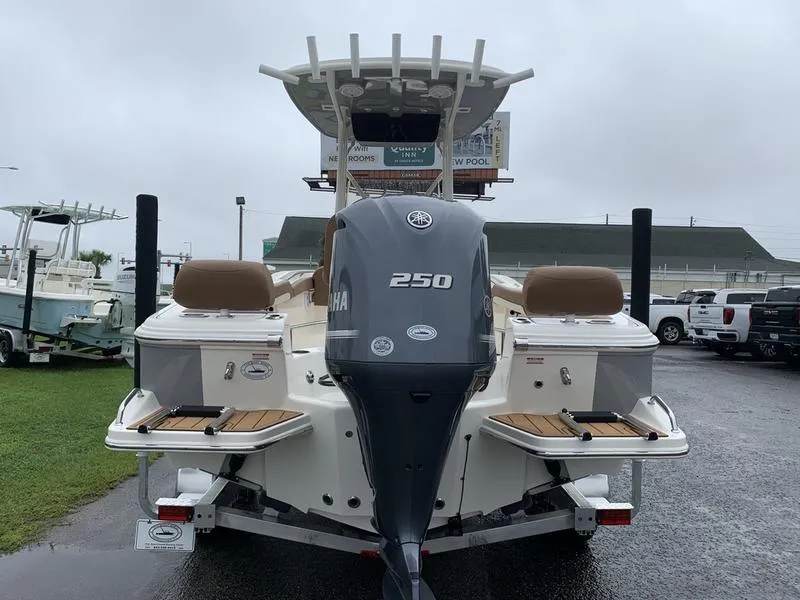 Slide: The Image of 2025 Pioneer SPORTFISH 222 boat with Yamaha 250 engine, parked outdoors. - 2