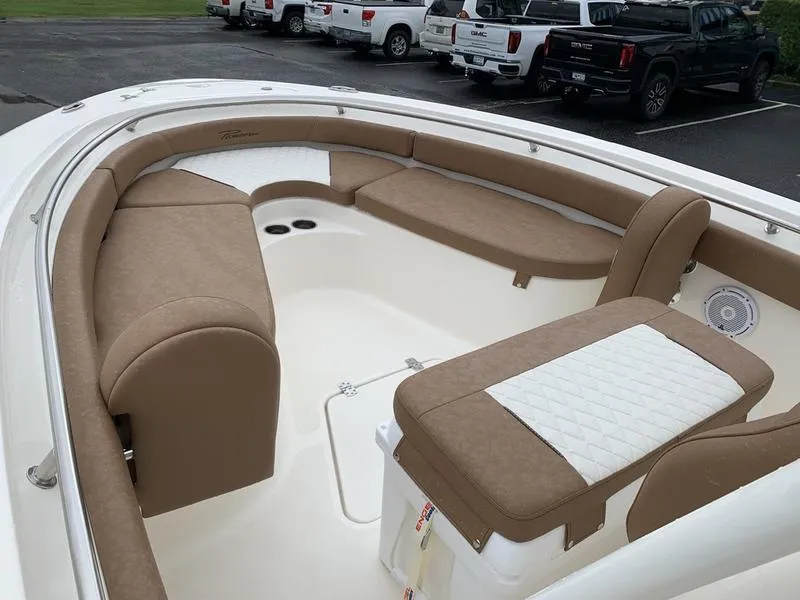 Slide: The Image of 2025 Pioneer SPORTFISH 222 boat interior with tan seating and white accents. - 24