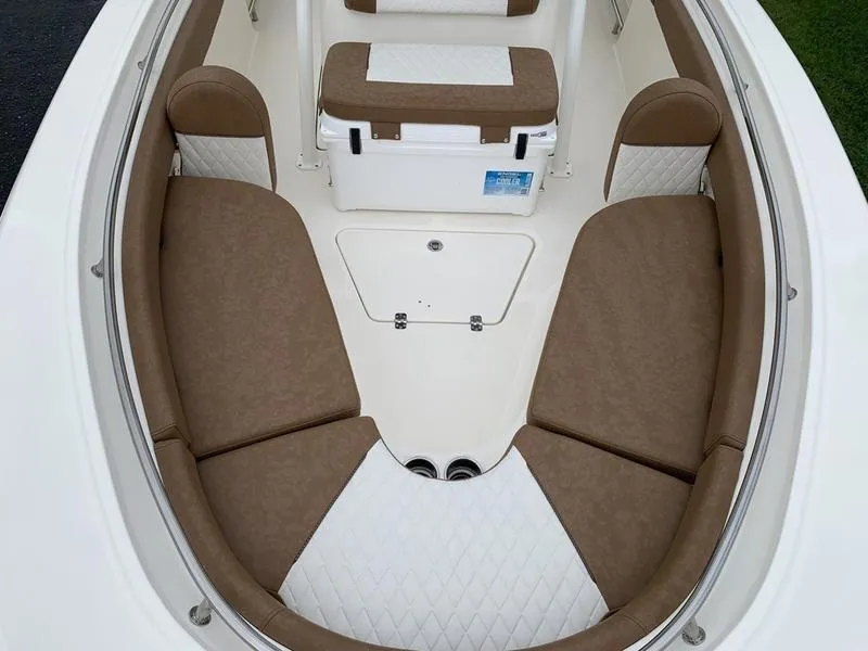 Slide: The Image of 2025 Pioneer SPORTFISH 222 boat interior with tan and white cushioned seating. - 28