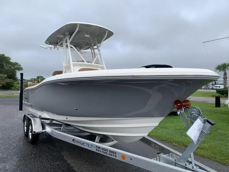 Slide: The Image of 2025 Pioneer SPORTFISH 222 boat on trailer, sleek design, overcast sky. - 5