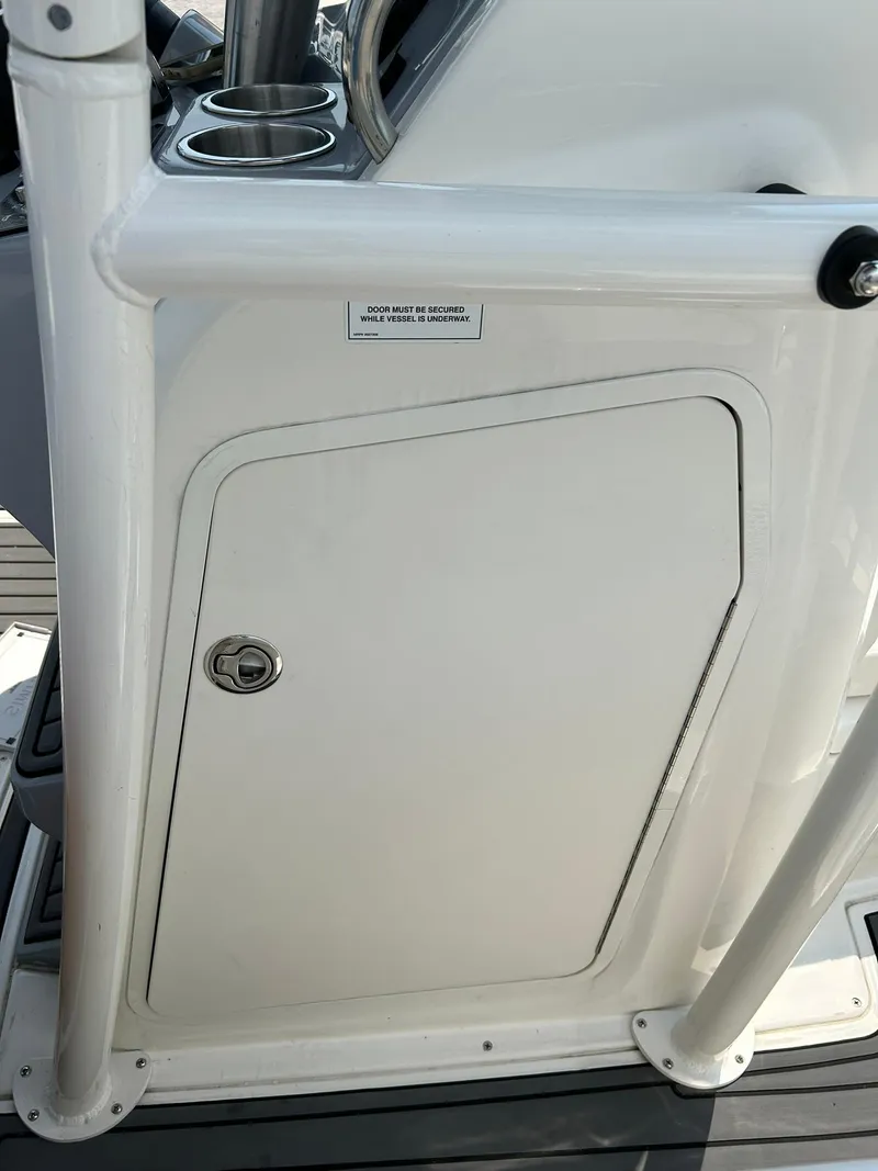 Slide: The Image of 2022 Bayliner Trophy T20CX boat console with storage compartment. - 10