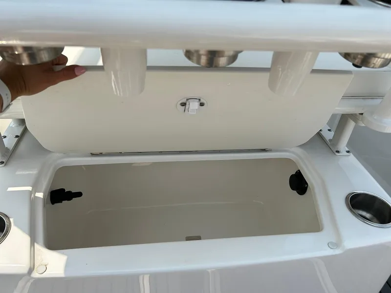 Slide: The Image of 2022 Bayliner Trophy T20CX boat storage compartment with rod holders. - 22
