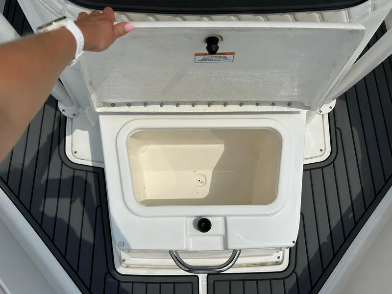 Slide: The Image of 2022 Bayliner Trophy T20CX boat storage compartment with open lid. - 9