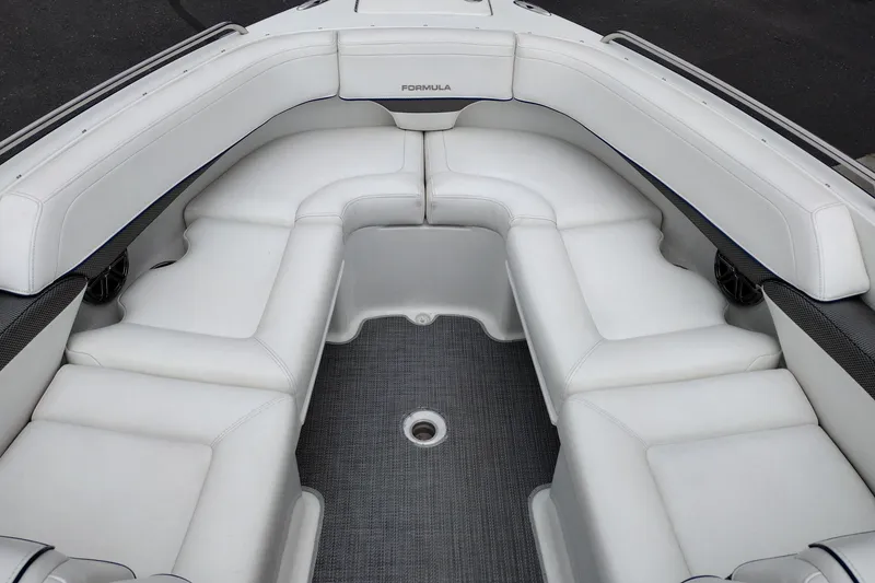 Slide: The Image of 2016 Formula 270 Bowrider boat interior with white cushioned seating and gray flooring. - 19