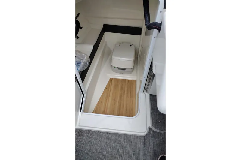 Slide: The Image of 2016 Formula 270 Bowrider interior with portable toilet and wood flooring. - 27