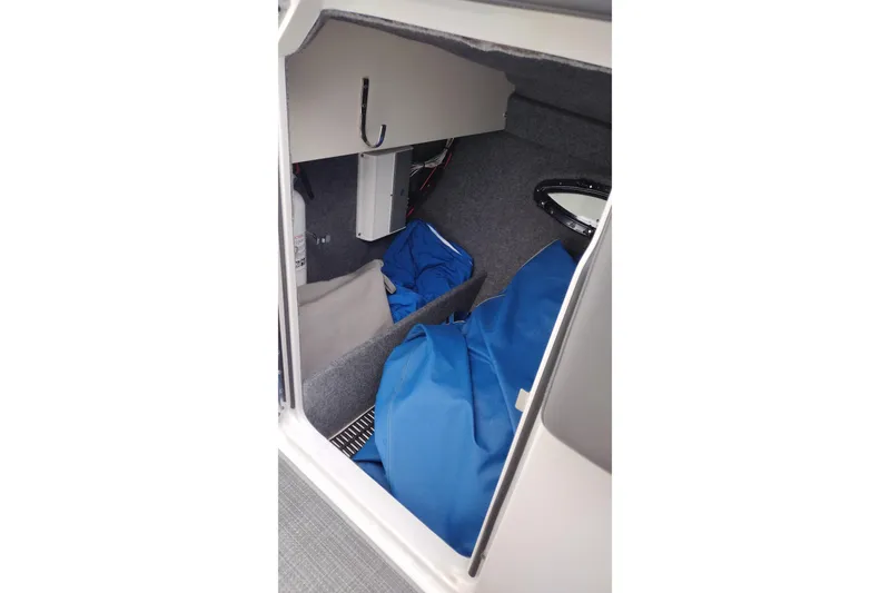 Slide: The Image of Interior storage compartment of 2016 Formula 270 Bowrider boat with blue cover. - 29