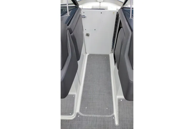 Slide: The Image of 2016 Formula 270 Bowrider interior walkway with gray flooring and cushioned seating. - 30