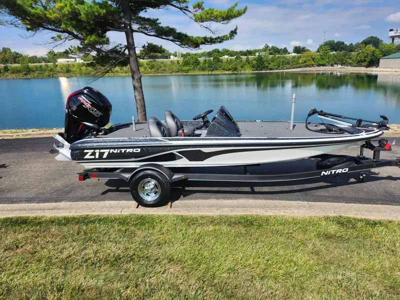 Slide: The Image of 2021 Nitro Z17 boat by a serene lake, showcasing sleek design and powerful engine. - 10