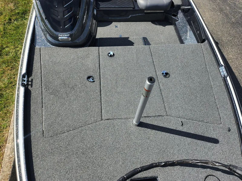 Slide: The Image of 2021 Nitro Z17 boat deck with gray carpet and fishing rod holder. - 17