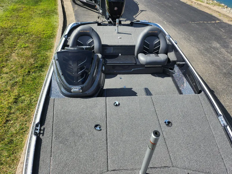 Slide: The Image of 2021 Nitro Z17 fishing boat with dual seats and storage compartments on a sunny day. - 18