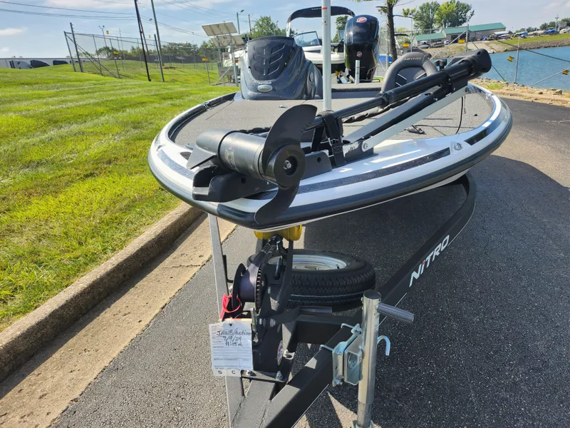 Slide: The Image of 2021 Nitro Z17 boat on trailer, parked near water, sunny day. - 7