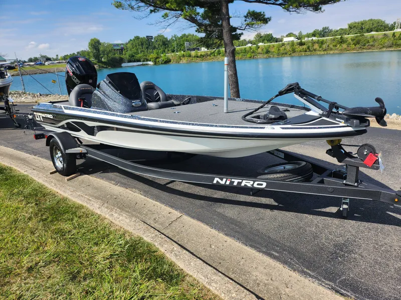 Slide: The Image of 2021 Nitro Z17 boat on trailer by a scenic lake. - 9